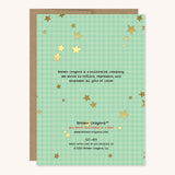 Back of greeting card with gold stars and green gingham background. It reads brown crayons is a multiracial company. we strive to reflect, represent and empower all girls of color. 