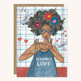 Heart Hands greeting card featuring a brown girl with natural hair afro making a heart shape with her hands. Sending Love.
