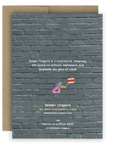 Back of holiday notecard. Gray brick will with text that reads brown crayons is a multiracial company. we strives to reflect, represent and empower all girls of color.